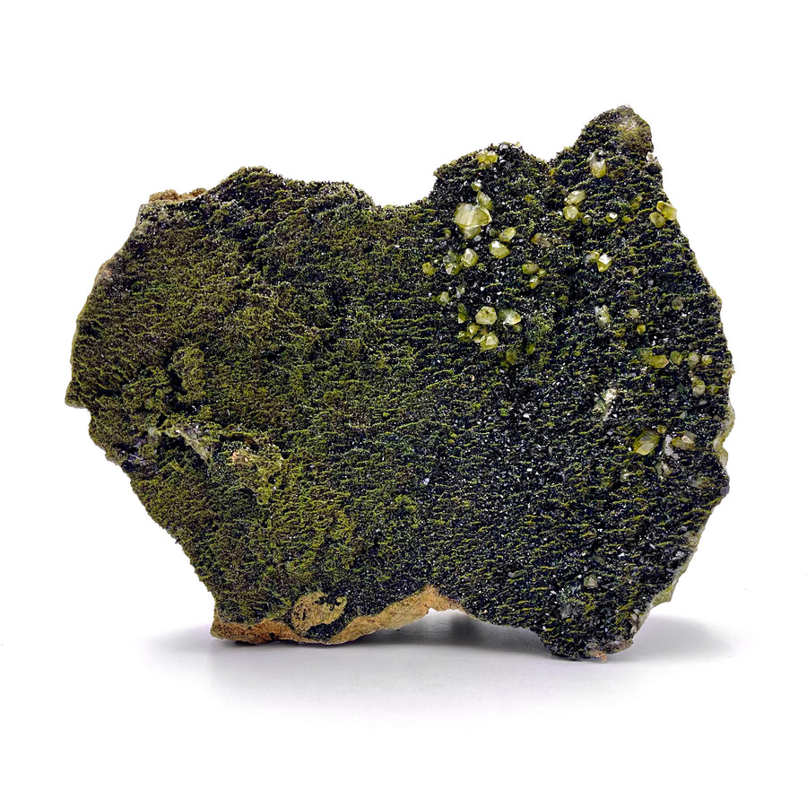 Mineral sample with green and black coloration on a white background