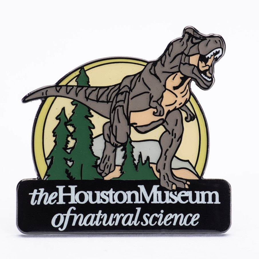 An enamel pin featuring an illustration of a T. rex dinosaur with the Houston Museum of Natural Science logo.