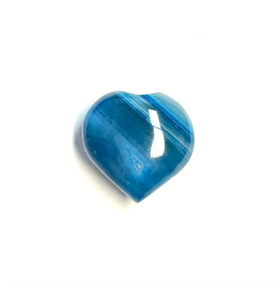 a carved heart from the mineral chalcedony features streaks of dark and pastel blue.