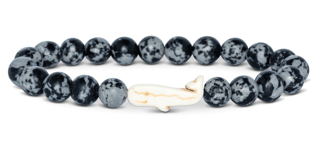 black and grey beaded bracelet with a whale bead on white background