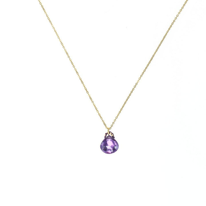 faceted amethyst pendant on a silk cord bail and gold chain necklace