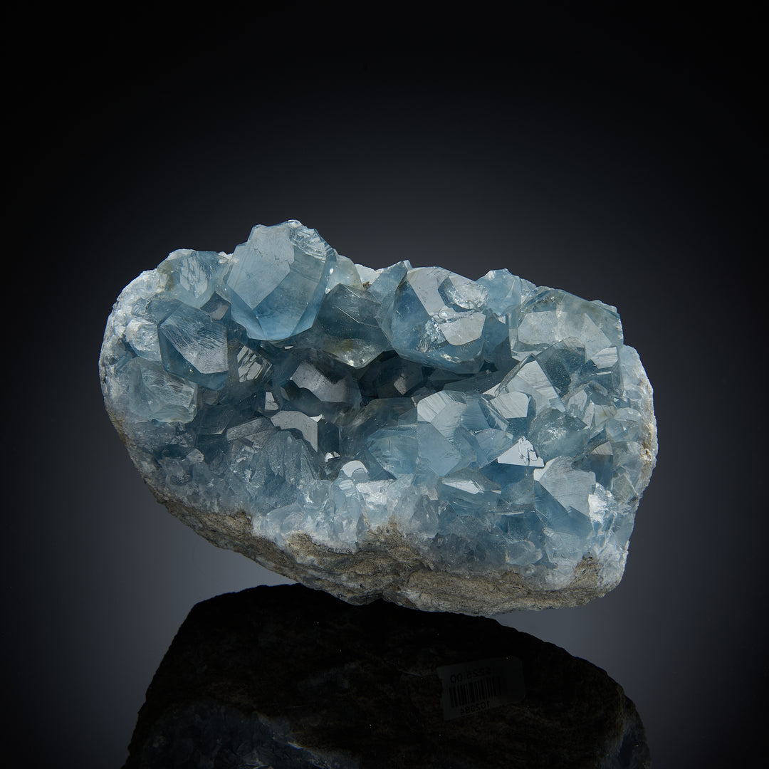 a celestite geode with light blue crystals inside, set against a black background