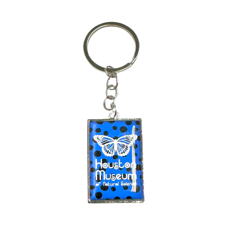 blue keychain with white butterfly and black dot decals