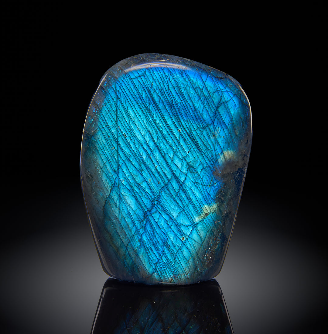a peacock blue labradorite specimen against a black background