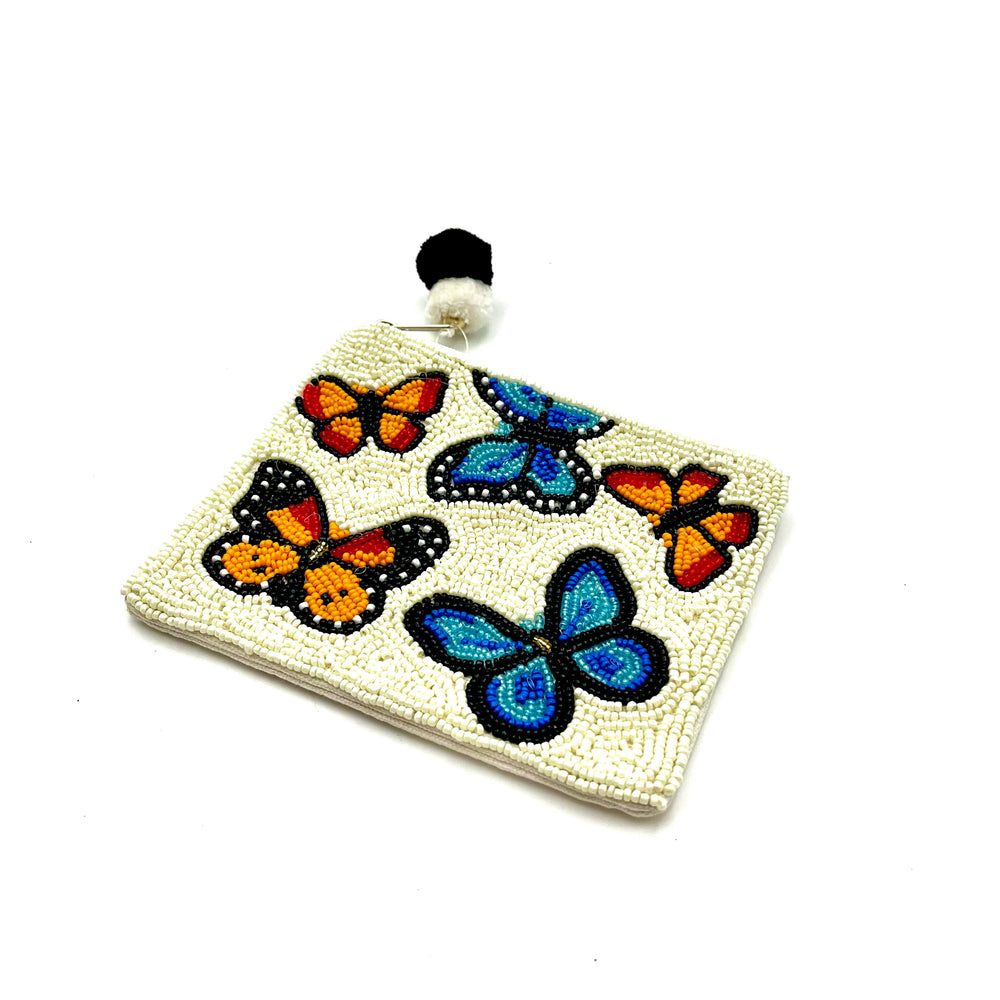 a white beaded coin purse with a variety of colorful butterflies