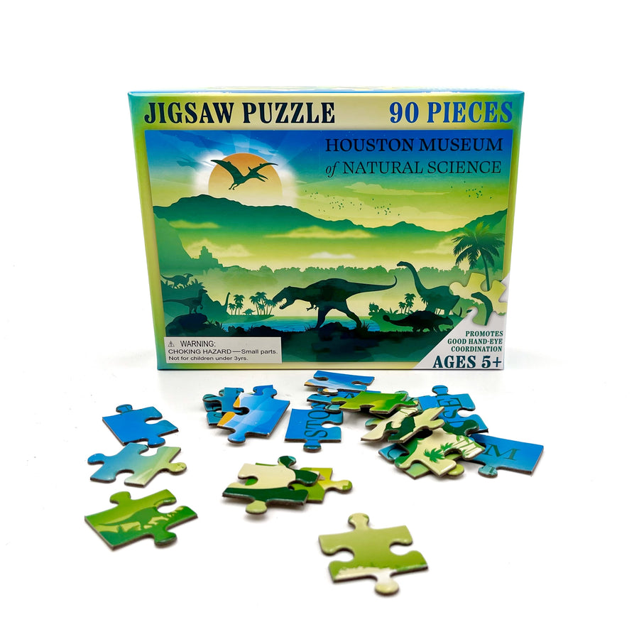 Jigsaw puzzle set with dinosaur-themed pieces and packaging from Houston Museum of Natural Science.