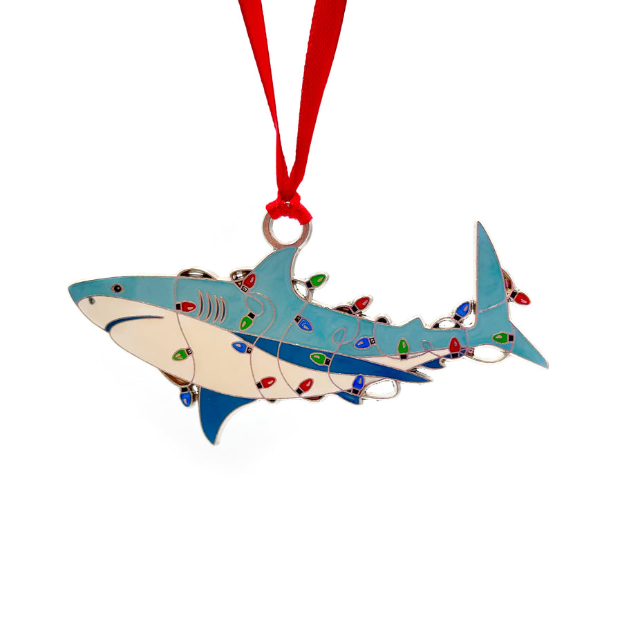 Shark-shaped Christmas ornament with colorful lights on a white background