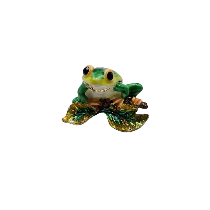 Green frog figurine on a white background