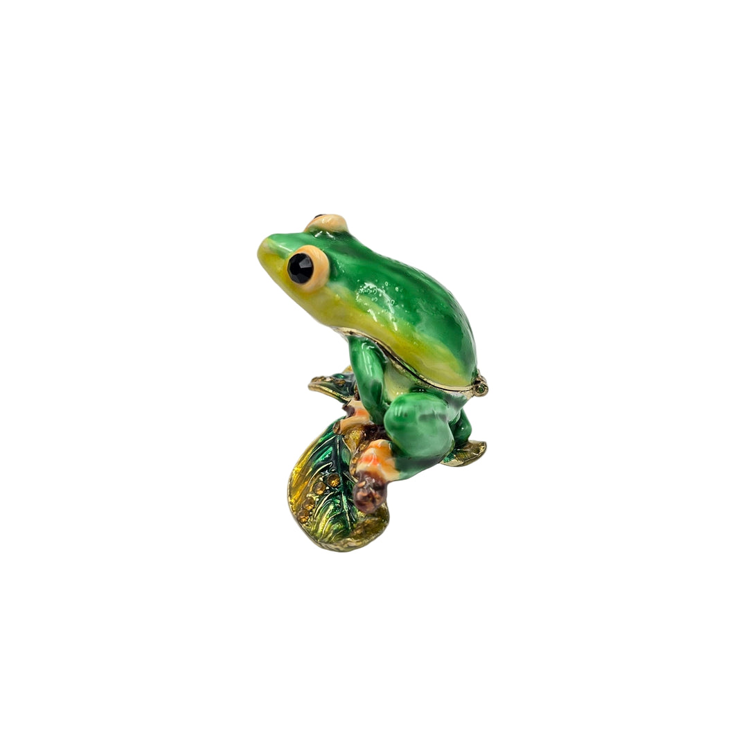 Green frog figurine on a white background