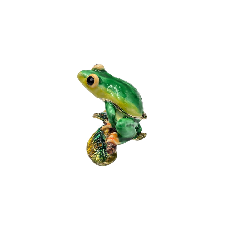 Green frog figurine on a white background