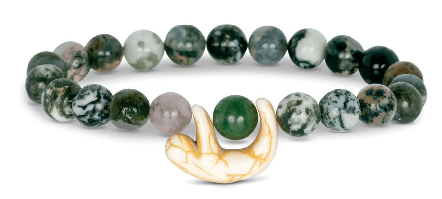 green and white beaded bracelet featuring a white and orange sloth bead on white background