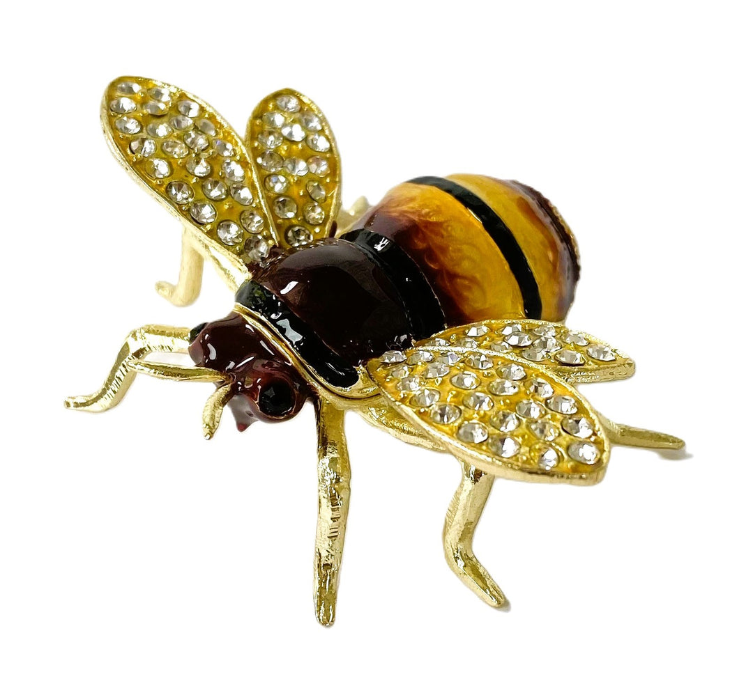 Gold bee-shaped trinket box with gemstones on a white background