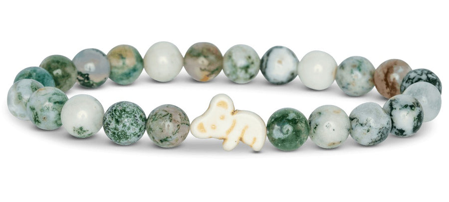 white and green beaded bracelet with a white koala bead on white background