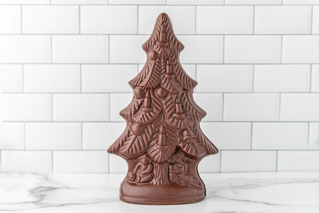 Chocolate tree-shaped mold on a white tiled background