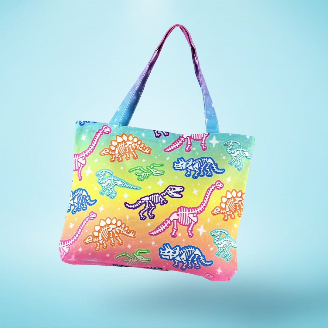 Colorful tote bag with dinosaur pattern on a gradient blue background