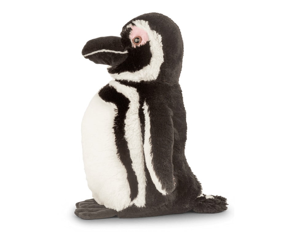 side view of a black and white penguin plush toy on white background