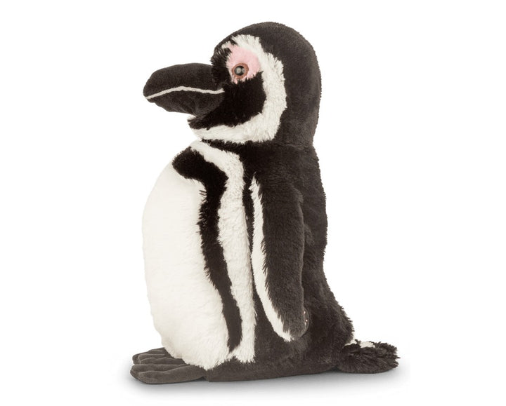 side view of a black and white penguin plush toy on white background