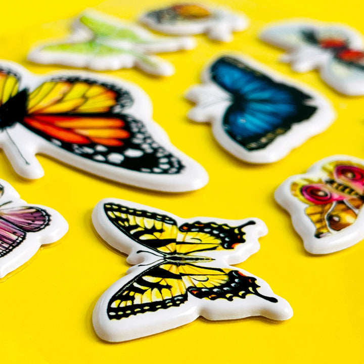 Colorful butterfly-shaped stickers on a yellow background