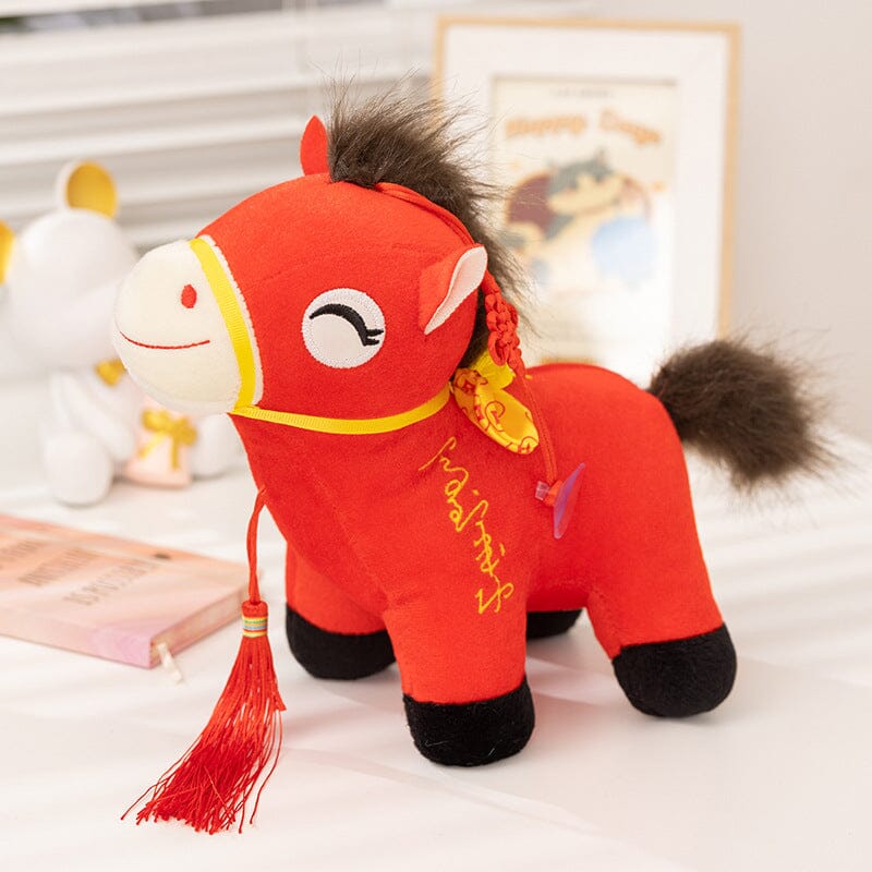 Red plush horse toy with decorative elements on a light background