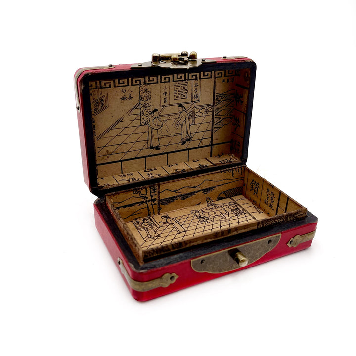 Red vintage curio box with intricate designs on a white background