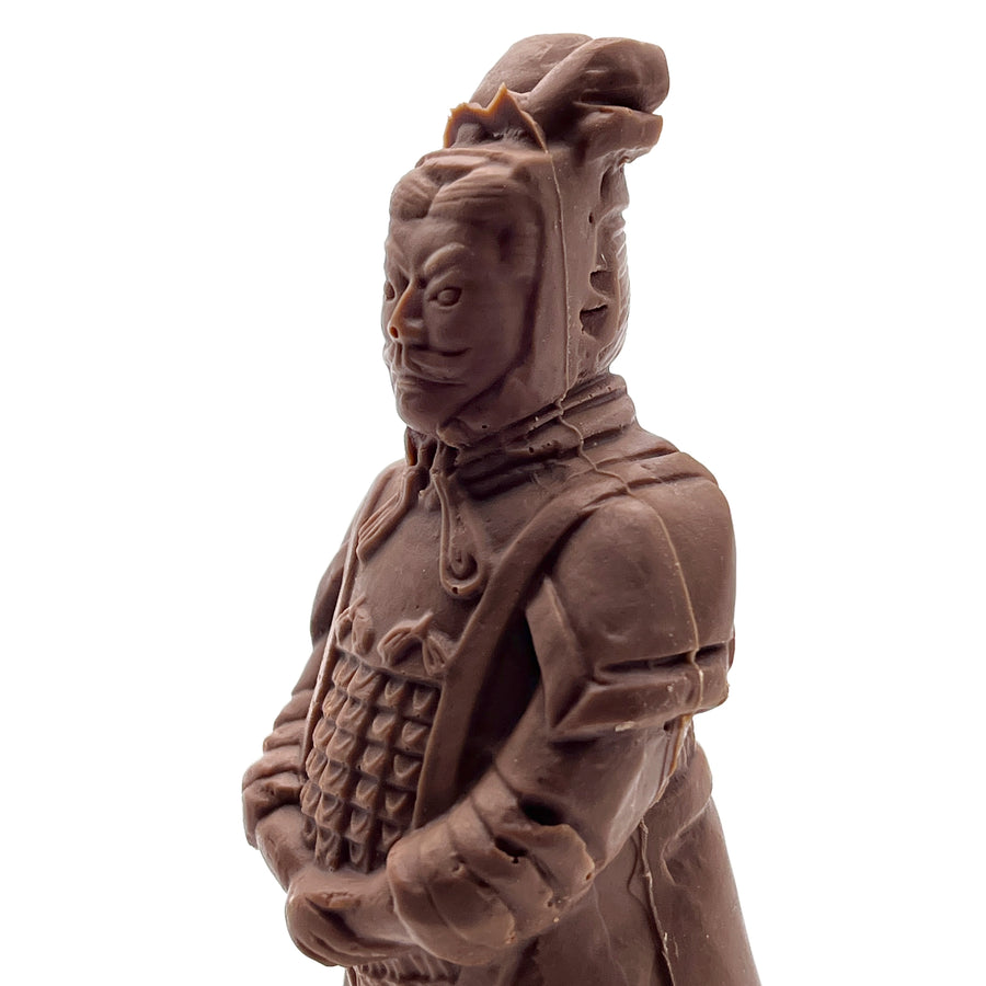 Chocolate figurine of a warrior in traditional armor on a white background