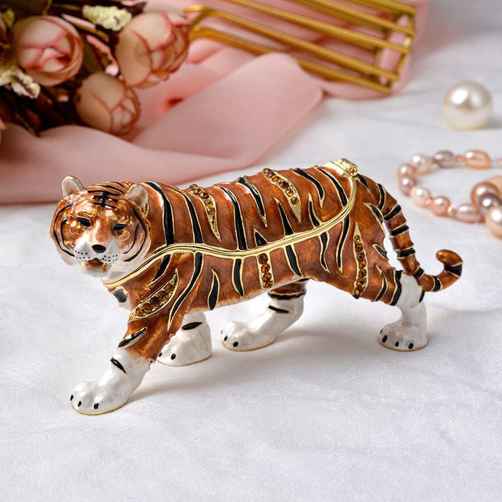 Decorative tiger figurine with jewelry on a white background
