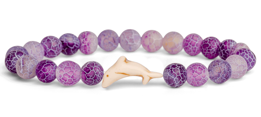 purple beads and a white dolphin bead on a white background